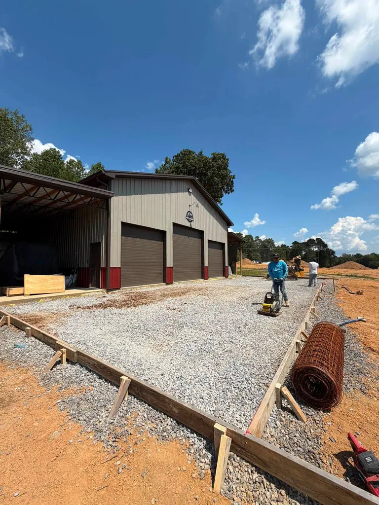 Forms and gravel base set in front of a shop building in Maryville, Tennessee