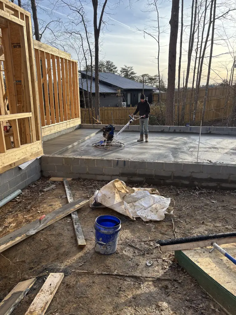 Finishing a concrete slab inside the framing of a new home in Maryville, Tennessee