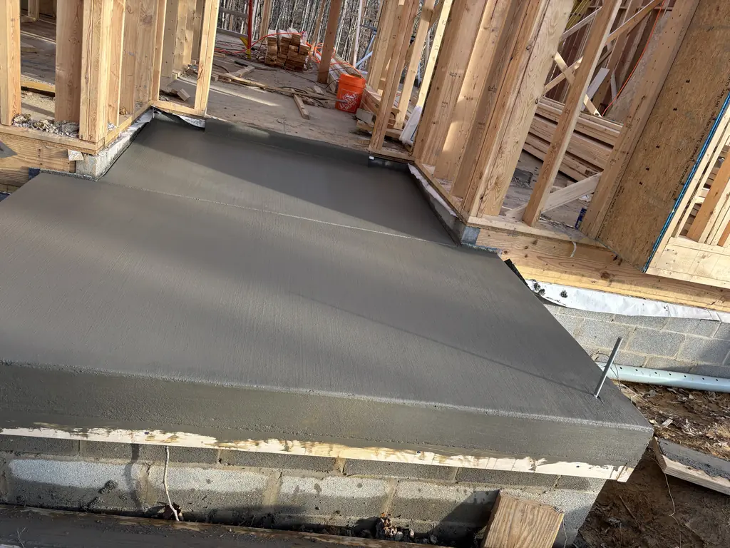 Fresh concrete slab poured inside the framing of a new home in Maryville, Tennessee
