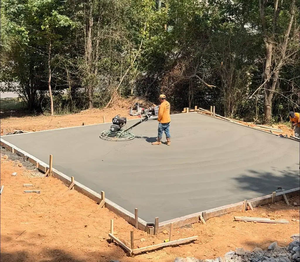 Maryville Concrete Pros crew running the power trowel across a fresh slab in Maryville, Tennessee
