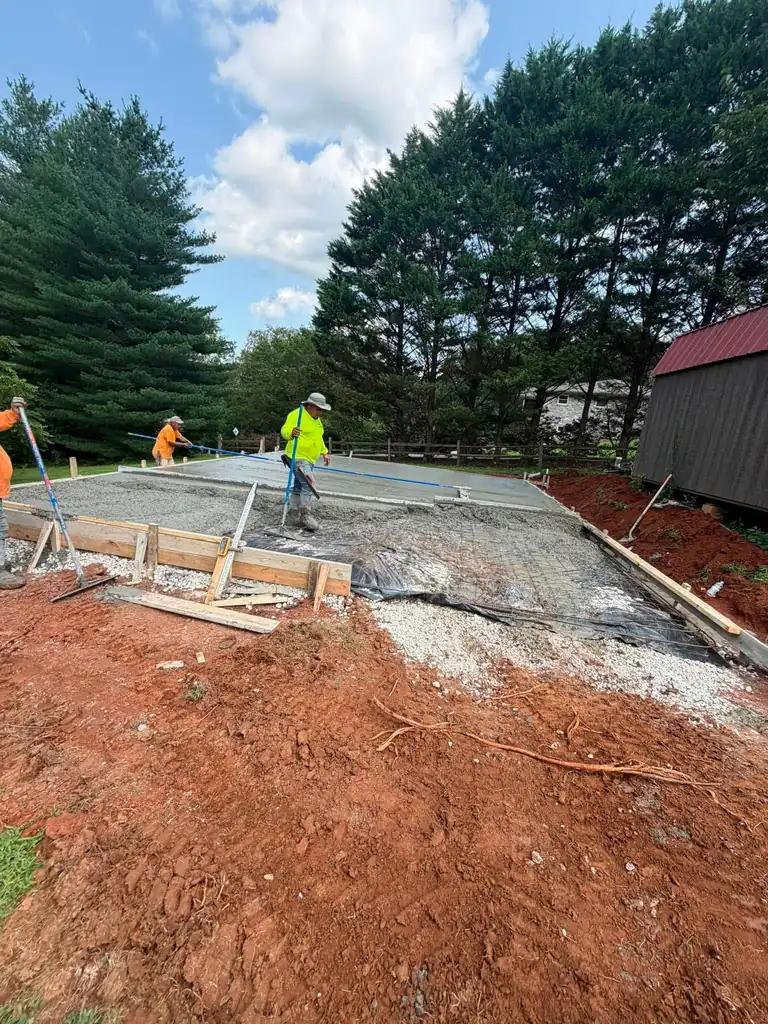 Screeding fresh concrete across a slab in Maryville, Tennessee