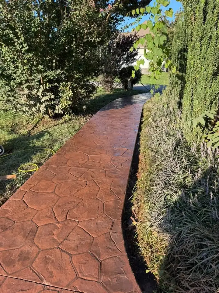 The same walkway repoured in patterned stamped concrete alongside the brick home in Maryville, Tennessee