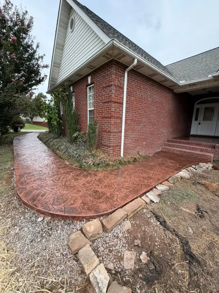 Stamped concrete walkway turning the front corner of a brick home in Maryville, Tennessee